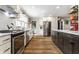 Bright kitchen with marble countertops, stainless steel appliances, and hardwood floors at 5626 Winthrop Ave, Indianapolis, IN 46220