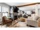 Spacious living room with a fireplace and wooden beams offering a relaxing atmosphere at 5626 Winthrop Ave, Indianapolis, IN 46220