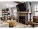 Cozy living room with a fireplace and built-in shelving, perfect for relaxation at 5626 Winthrop Ave, Indianapolis, IN 46220