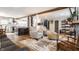 Bright open concept living area with hardwood floors connecting living and kitchen spaces at 5626 Winthrop Ave, Indianapolis, IN 46220