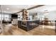 Open floor plan showcasing the kitchen, living room, and dining area with hardwood floors at 5626 Winthrop Ave, Indianapolis, IN 46220