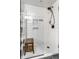 Sleek, modern shower with white tile and a glass door, offering a spa-like experience at 5626 Winthrop Ave, Indianapolis, IN 46220