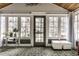 Bright sunroom with lots of windows, unique flooring, and stylish furnishings, creating a relaxing atmosphere at 5626 Winthrop Ave, Indianapolis, IN 46220
