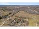 Scenic aerial perspective of the house and neighborhood, nestled amongst fields, trees, and homes at 6724 E Spring Lake Rd, Mooresville, IN 46158