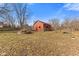Backyard with a red barn, fire pit and natural landscape at 6724 E Spring Lake Rd, Mooresville, IN 46158