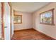 Neutral bedroom with two windows and laminate flooring with brick accents at 6724 E Spring Lake Rd, Mooresville, IN 46158
