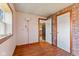 Bedroom with laminate wood flooring, two windows, and a brick accent wall at 6724 E Spring Lake Rd, Mooresville, IN 46158