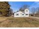 Quaint white home with green shutters, inviting entrance, and mature trees in a tranquil neighborhood at 6724 E Spring Lake Rd, Mooresville, IN 46158