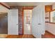 Hallway with brick accent wall leading to multiple rooms and access to bathroom at 6724 E Spring Lake Rd, Mooresville, IN 46158