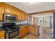 Eat-in kitchen with stainless steel appliances, brick accents, and wood cabinets at 6724 E Spring Lake Rd, Mooresville, IN 46158