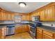Well-lit kitchen features stainless steel appliances and ample wood cabinet storage at 6724 E Spring Lake Rd, Mooresville, IN 46158