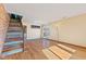 Inviting living area with hardwood floors, staircase, brick wall, and sliding glass door leading to the outside at 6724 E Spring Lake Rd, Mooresville, IN 46158