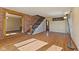 Spacious living area with hardwood floors, brick accent wall, staircase, and large windows at 6724 E Spring Lake Rd, Mooresville, IN 46158
