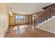 Hardwood floors, brick accent wall, staircase, and ample natural light in this expansive living space at 6724 E Spring Lake Rd, Mooresville, IN 46158