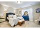 Bright bedroom with blue accents, including a dresser and stylish lamps at 7091 Lillian Pl, Cumberland, IN 46229
