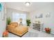 Bedroom boasts natural light, neutral colors, and a chaise lounge for relaxation at 7091 Lillian Pl, Cumberland, IN 46229