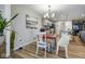 Dining area with a red table, stylish chairs, and views into the kitchen at 7091 Lillian Pl, Cumberland, IN 46229