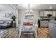 Charming dining area with a stylish red table and a view of the comfortable living space at 7091 Lillian Pl, Cumberland, IN 46229