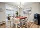 Charming dining room featuring elegant seating, a chandelier, and warm neutral decor at 7091 Lillian Pl, Cumberland, IN 46229