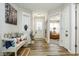 Charming entryway with bench seating, wood floors, natural light and view to living area at 7091 Lillian Pl, Cumberland, IN 46229
