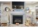 Cozy fireplace with a decorative mantel, large television, and stylish decor at 7091 Lillian Pl, Cumberland, IN 46229