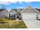 Charming single-story home with gray siding, a two-car garage, and a well-manicured front yard at 7091 Lillian Pl, Cumberland, IN 46229