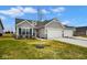 Charming single-story home with gray siding, a two-car garage, and a well-manicured front yard at 7091 Lillian Pl, Cumberland, IN 46229