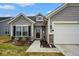 Charming single-story home with gray siding, a two-car garage, and a well-manicured front yard at 7091 Lillian Pl, Cumberland, IN 46229