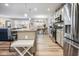 Spacious kitchen featuring stainless steel appliances and island that transitions to the dining area at 7091 Lillian Pl, Cumberland, IN 46229