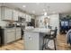 Stylish kitchen featuring an island, stainless steel appliances, and modern lighting at 7091 Lillian Pl, Cumberland, IN 46229
