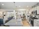 Open-concept kitchen with granite counters and stainless appliances, flowing into the dining and living areas at 7091 Lillian Pl, Cumberland, IN 46229