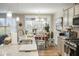 Open-concept kitchen with granite counters and stainless appliances, flowing into the dining area at 7091 Lillian Pl, Cumberland, IN 46229