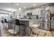Open kitchen with stainless steel appliances and large island with barstool seating at 7091 Lillian Pl, Cumberland, IN 46229