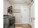 Neutral laundry room with modern washer and dryer, storage, and door to the outside at 7091 Lillian Pl, Cumberland, IN 46229