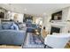 Spacious living room with a plush blue sectional, fireplace, and view into the kitchen at 7091 Lillian Pl, Cumberland, IN 46229