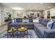 Cozy living space featuring a comfortable sectional sofa, stylish decor, and connection to dining area at 7091 Lillian Pl, Cumberland, IN 46229