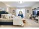 Cozy main bedroom with a queen bed, neutral walls, and stylish decorations at 7091 Lillian Pl, Cumberland, IN 46229