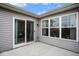 Rear patio with sliding glass door and multiple windows at 7091 Lillian Pl, Cumberland, IN 46229