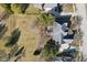Aerial view of a home with a spacious lawn, driveway, and mature trees on a sunny day at 7238 River Birch Ln, Indianapolis, IN 46236