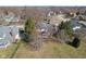 Aerial view of a home with a large yard, screened porch, and mature trees on a sunny day at 7238 River Birch Ln, Indianapolis, IN 46236