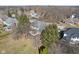 Aerial view of a home showcasing a large yard, screened porch, and mature trees on a sunny day at 7238 River Birch Ln, Indianapolis, IN 46236