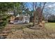 Exterior view of a screened-in porch and backyard surrounded by trees at 7238 River Birch Ln, Indianapolis, IN 46236