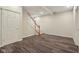 Finished basement area with wood-look floors and stairs leading to another level at 7238 River Birch Ln, Indianapolis, IN 46236