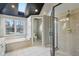 This well-lit bathroom features a skylight and separate shower and tub at 7238 River Birch Ln, Indianapolis, IN 46236