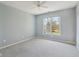 A light-filled bedroom featuring neutral walls and carpet, a ceiling fan, and a window to the outside at 7238 River Birch Ln, Indianapolis, IN 46236
