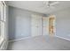 A light-filled bedroom featuring neutral walls and carpet and double closets with a view to the hallway at 7238 River Birch Ln, Indianapolis, IN 46236
