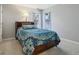 A cozy bedroom features a blue patterned comforter, two windows, and a neutral carpet at 7238 River Birch Ln, Indianapolis, IN 46236