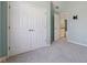 A bedroom featuring double closets, blue walls, neutral carpet, and a view of the hallway at 7238 River Birch Ln, Indianapolis, IN 46236