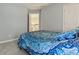A comfortable bedroom with a view of the hall and a blue patterned comforter on the bed at 7238 River Birch Ln, Indianapolis, IN 46236