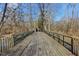 Experience a peaceful stroll on the wooden bridge, offering serene views of the surrounding nature and creek at 7238 River Birch Ln, Indianapolis, IN 46236